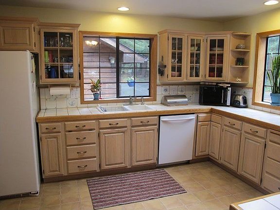 Spacious kitchen has oak cabinets