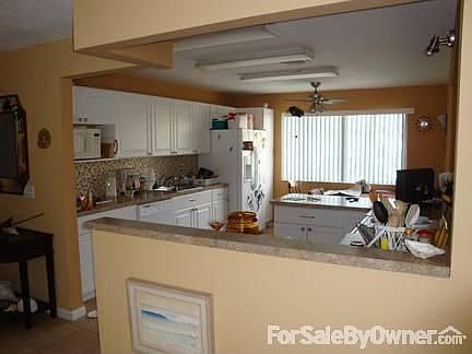 The kitchen looking towards the living room and front of house.