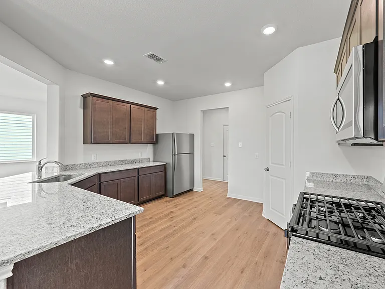 The spacious kitchen has upgraded features that make cooking and cleaning more enjoyable.