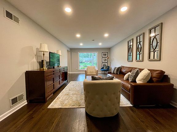 A large picture window in the living room overlooking the front lawn