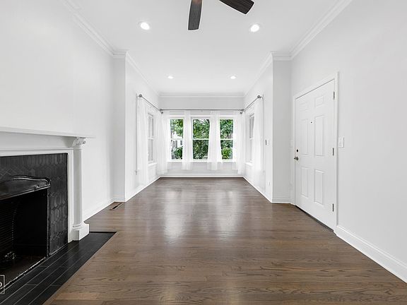 Living area with hardwood floors and decorative fireplace
