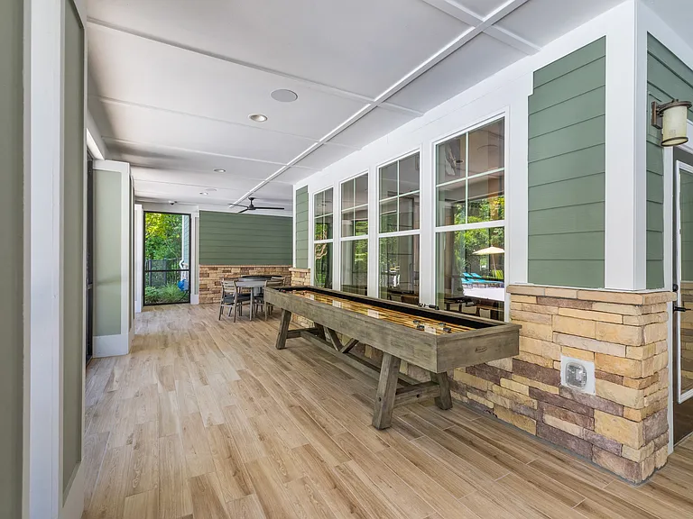 Langley Pointe Apartments | Screened in Patio w/ Shuffleboard