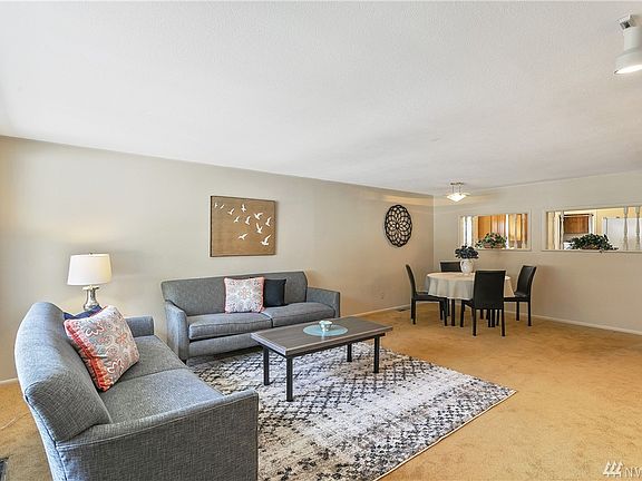 This warm and inviting living and dining room welcomes you home. You'll enjoy a peek-a-boo view into the kitchen as well. The interior of the home has just been freshly painted.