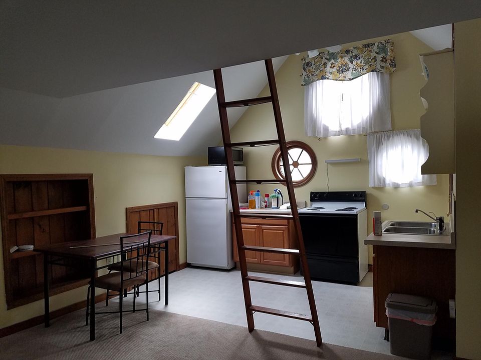 Kitchen dining area. Full size frig, stove and cabinet, sky lights, book case, storage in eves.