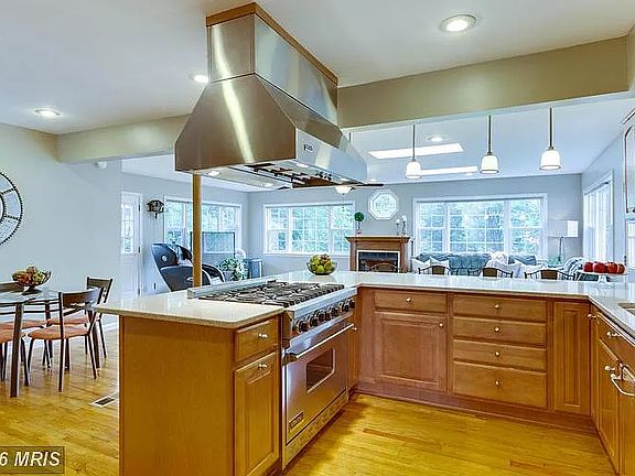 Kitchen from the entry hallway just past the front living room with the rear large sunroom/grand-room