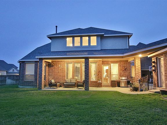 The back covered patio has a gas stub for easy grilling and a covered breezeway to the detached garage.