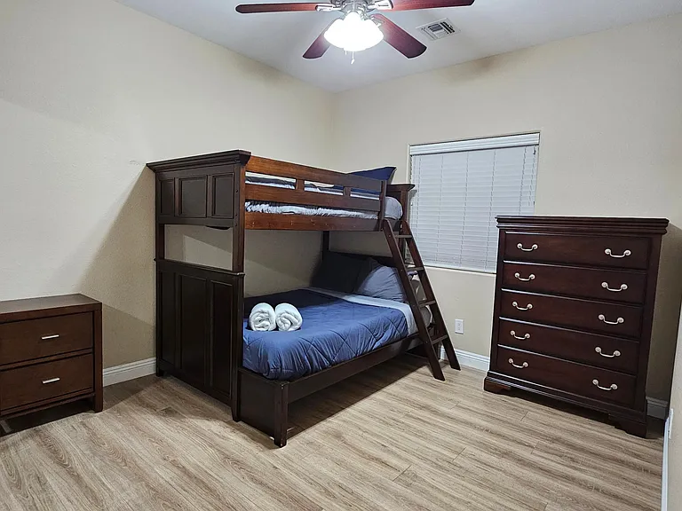 Bedroom 3 - Bunk Beds (1 full/1 twin mattress), dresser, night stand, closet, and ceiling fan.