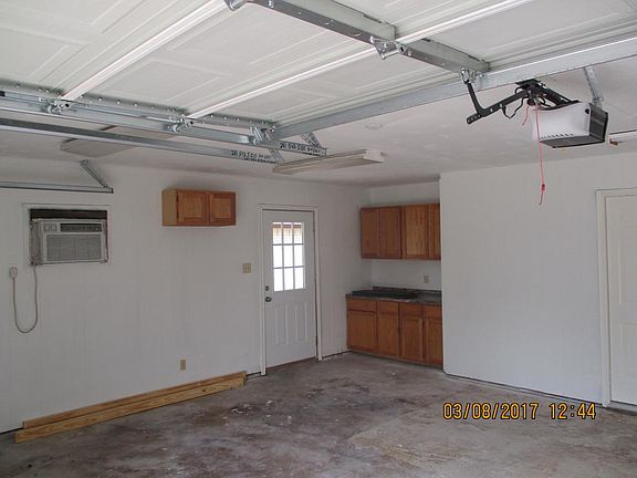 Garage has an opener, workbench, and an ac.