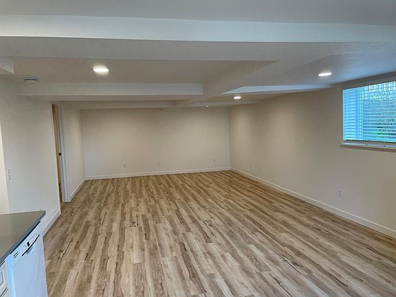 View of dining and living area from the kitchen. Bedroom entrance can be seen in the rear of the room on the left.
