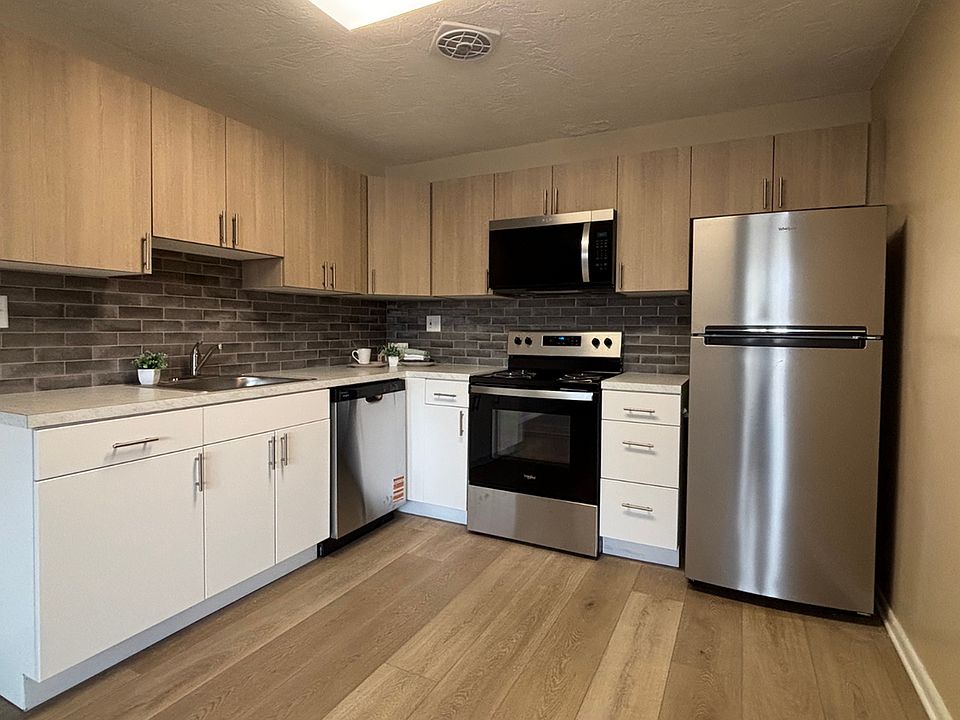 Contemporary kitchen featuring stainless steel appliances, sleek cabinetry, and stylish finishes at Audubon Arms Apartments.