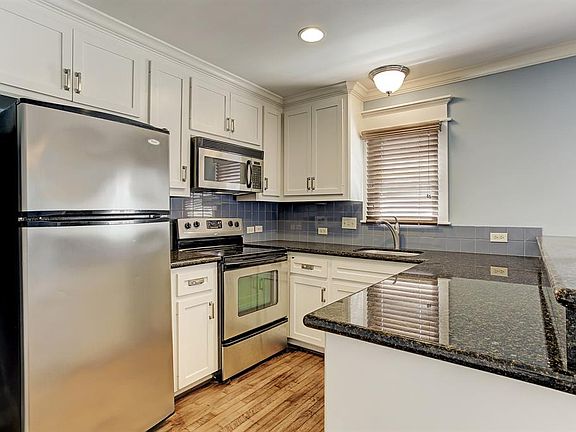 The kitchen is spacious and boasts, granite counter tops & SS appliances.