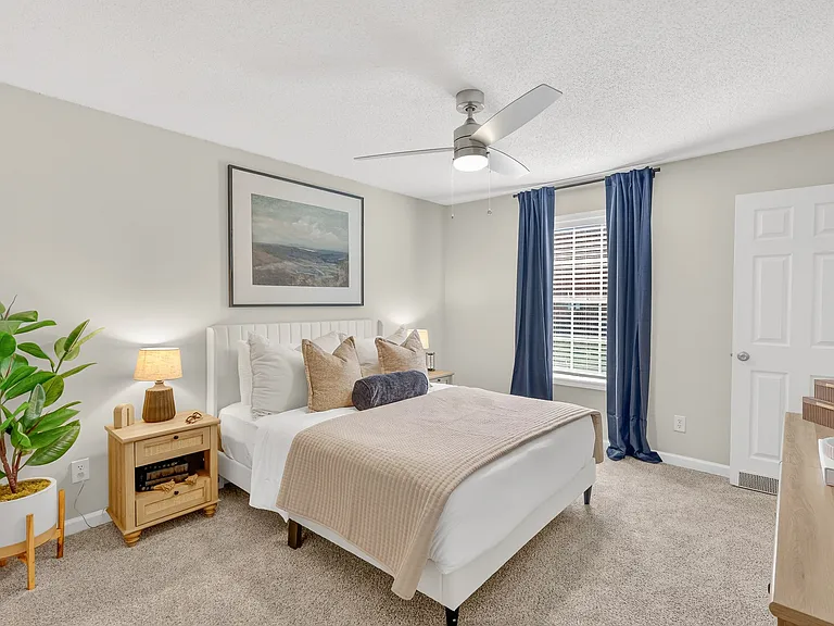 Bright bedroom with modern ceiling fan at Saddlebrook Apartments