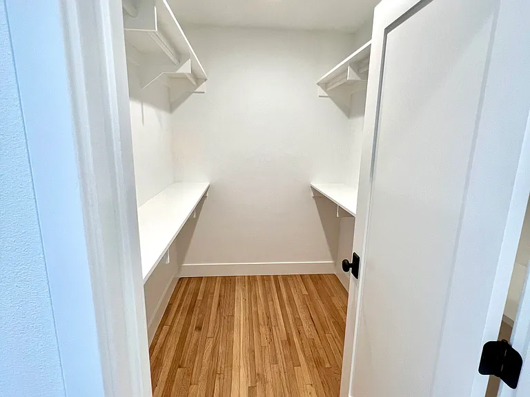 Primary Bedroom: Large walk-in closet with 6-drawer white dresser (not pictured here)