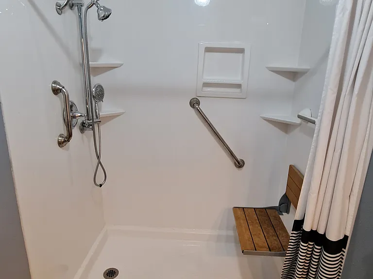 Hallway Bathroom with Large Shower and seat that folds down if needed.