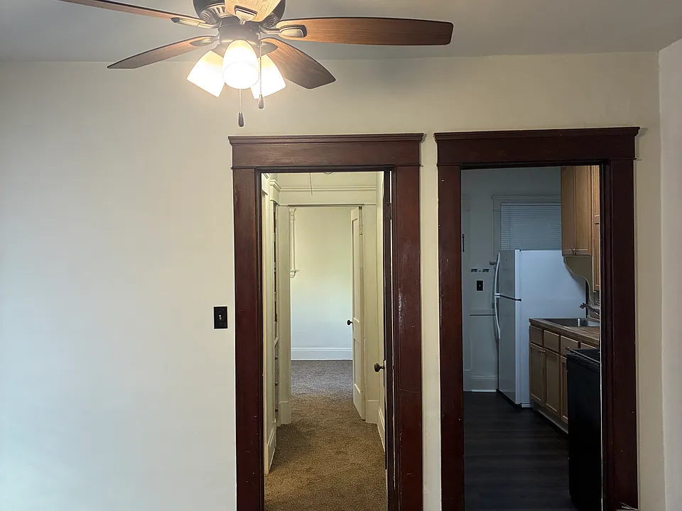 Living room or office from living room to hallway and kitchen to right doorway. New carpeting. New paint, new ceiling fans, complete renovation.
