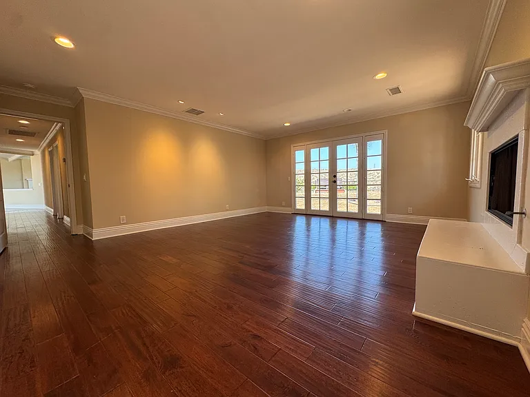 Primary bedroom with wood flooring
