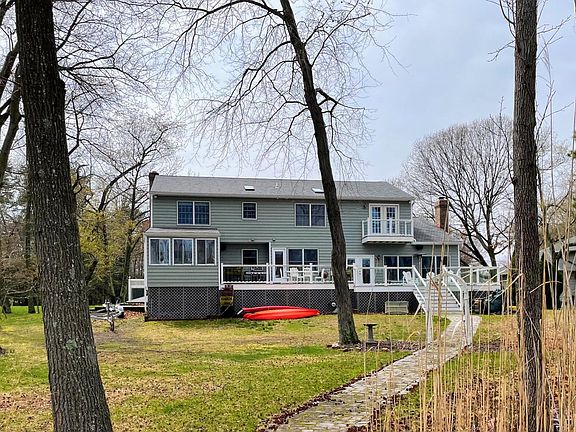 Back of house with large deck