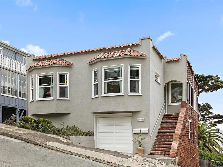 Front of house with side driveway to parking area in rear. Apartment for rent is at back of house facing water view.