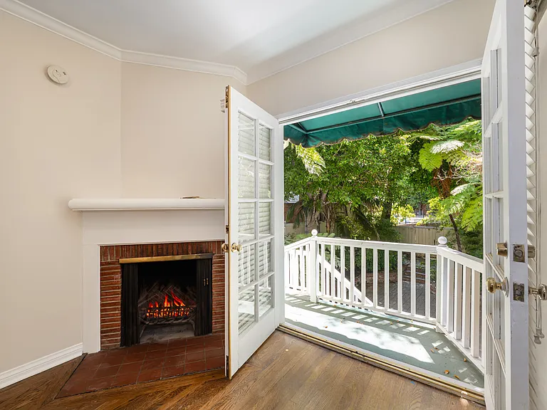 Bedroom 1 with Fireplace and Balcony Deck leading to Backyard