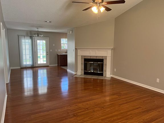 Open floor plan. Living and dining rooms adjacent to the kitchen. French doors out to the covered patio area.