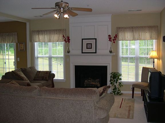 Open family room with custom fireplace mantle.