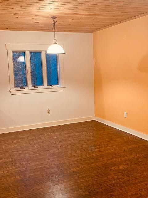 First floor is open floor plan living room, dining room and kitchen, with hardwood floors. Windows look out on wooded backyard where there are plentiful birds and wildlife year round.