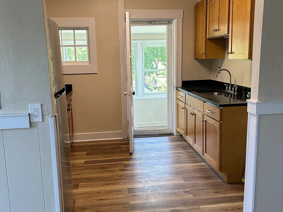 View of 'galley' kitchen. Stackable washer/dryer hook-up is to right of counter with sink.