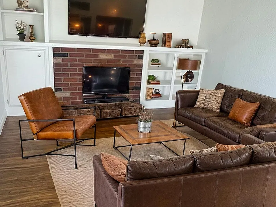 Living area has built ins and faux fireplace