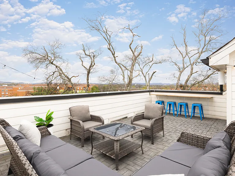 Private rooftop deck with plenty of seating and outdoor lights, allowing you to enjoy your morning cup of coffee or a late night conversation while overlooking the skyline.