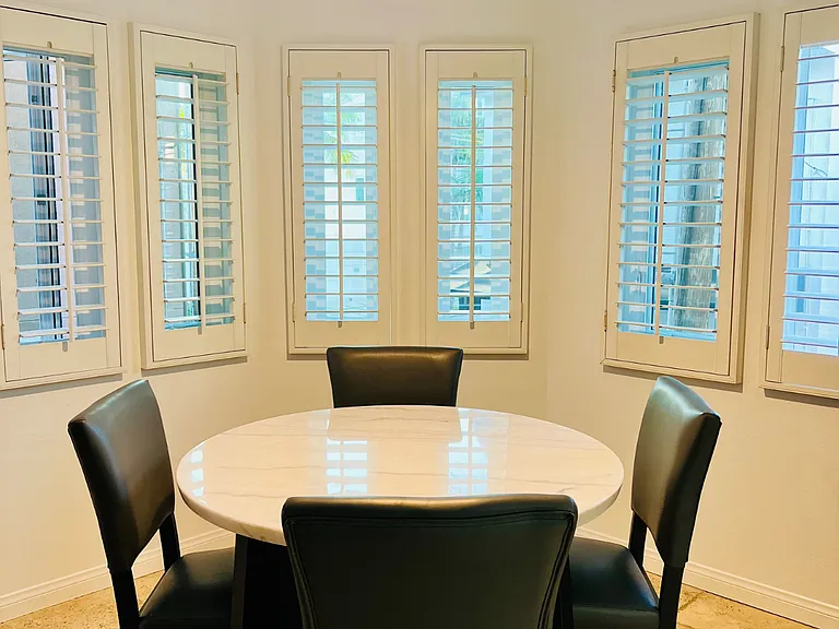 The sun streams through to the marble kitchen table which seats 4.