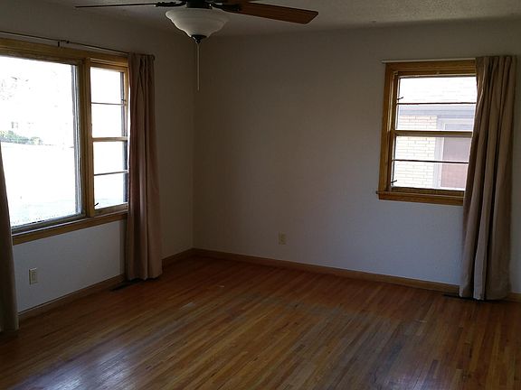 Large, open-concept living room with hardwood floors.