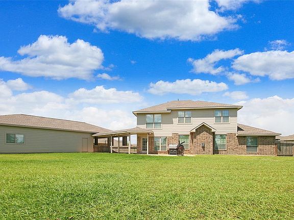 Porte Cochere to 6 Car Garage, Bathroom, & Additional Parking Space & Outdoor Patio