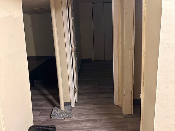 Hallway view of living room, bed room, and dehumidifier