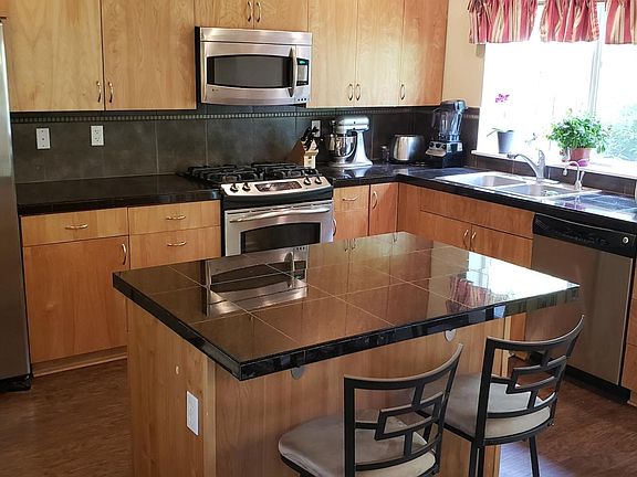 Open kitchen with stainless steel appliances