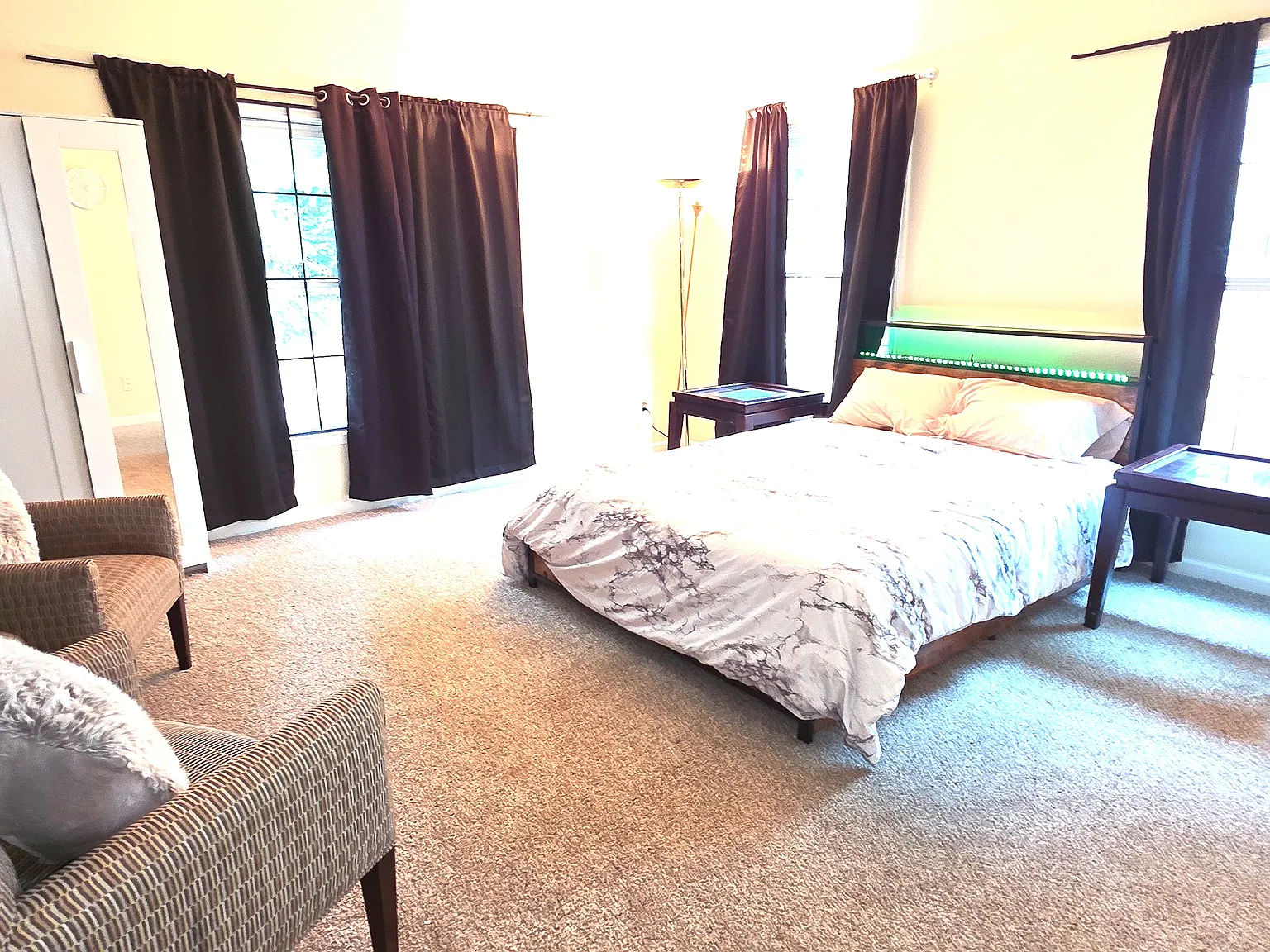 Fully furnished bed room with bed, mattress, walk in closet, extra cupboard, arm chairs, lamp, curtains, computer table/chair and ensuite full bath