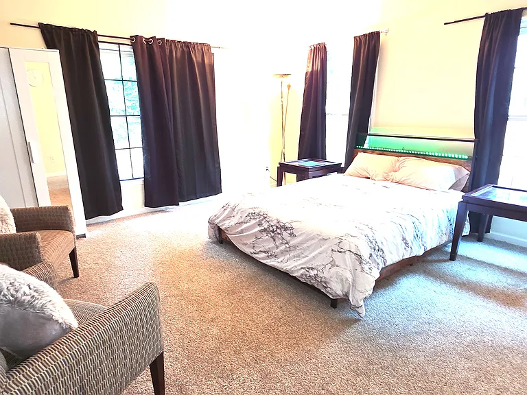 Fully furnished bed room with bed, mattress, walk in closet, extra cupboard, arm chairs, lamp, curtains, computer table/chair and ensuite full bath