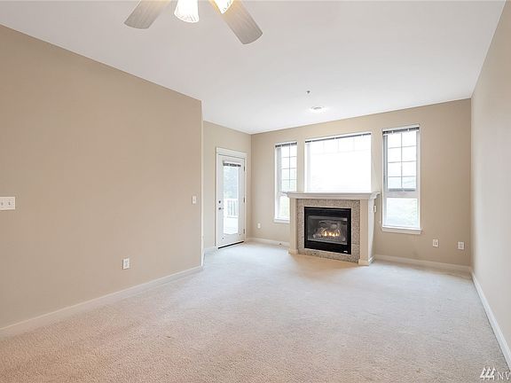 Great-Room area of home (entry/kitchen/living areas combine).   Natural gas fireplace works with a thermostat to drive area to t