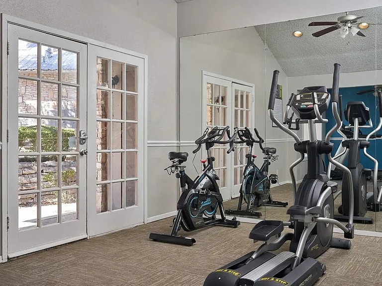 Uncover a fitness haven at Distinction Apartment Homes, featuring a spacious gym filled with modern equipment and ample natural light. Elevate your lifestyle and enhance your wellness journey. Schedule a tour today!