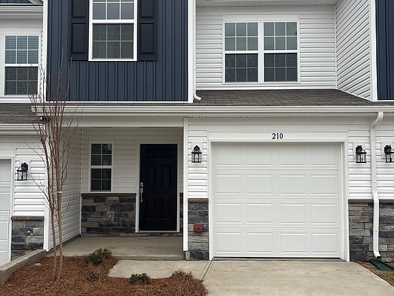 Home front with one-car garage and driveway fitting 2 cars.