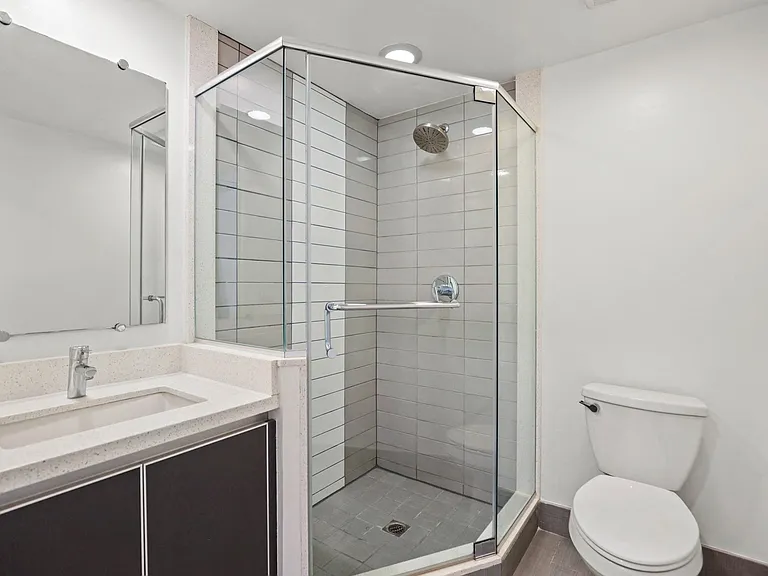 Bathroom with a Stand-Up Shower with Glass Doors and Vanity with Cabinets