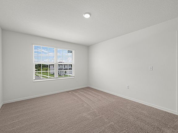 The spacious master bedroom has a large window