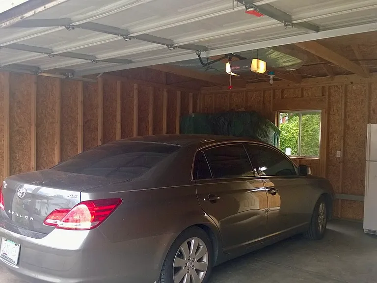 interior of garage (fridge is now gone). Good alley access to park two large vehicles). WIFI garage door opener and keyless entry
