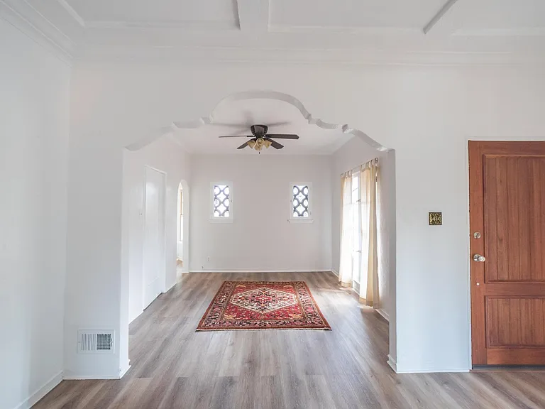 View of dining room from living room. Front door on right