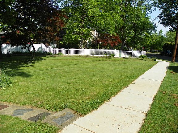 New Front sidewalk with 703 separate sidewalk by white picket fence