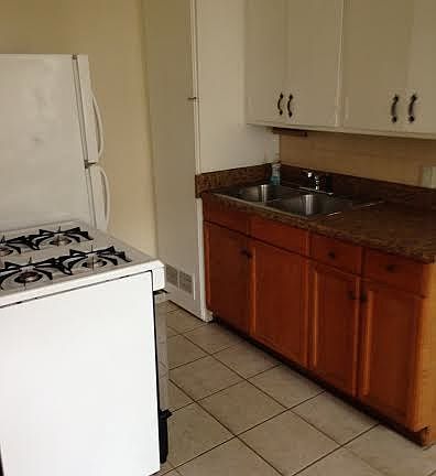 Kitchen with gas stove and frig