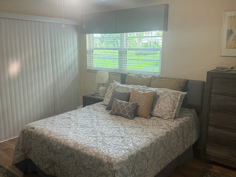 Second bedroom with queen bed and 55" TV.