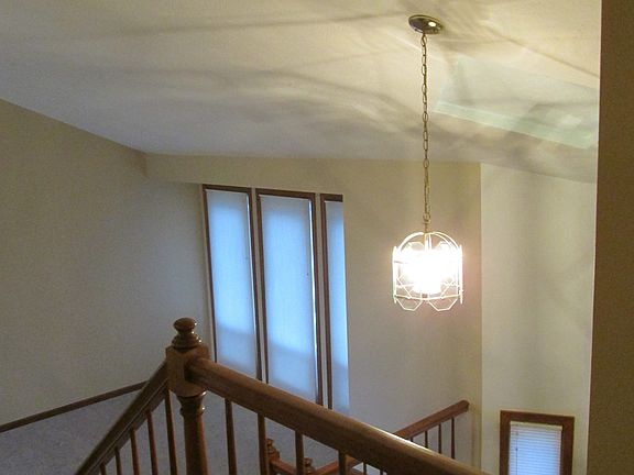 looking down on living room and entry from 2nd floor hallway