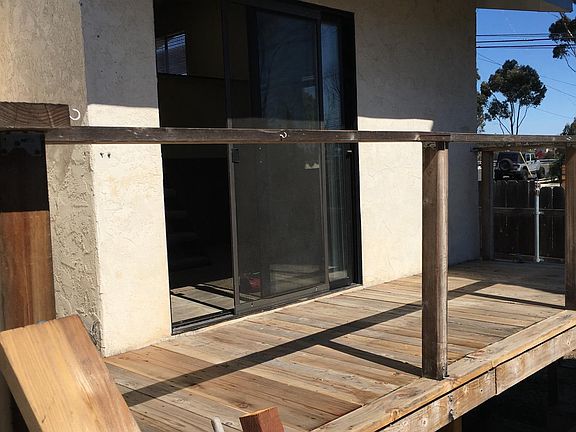 Large deck leading to fenced in yard