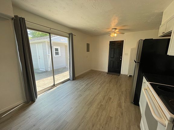 Side door to driveway from the kitchen. Sliding glass door to the backyard and detached one-car garage.