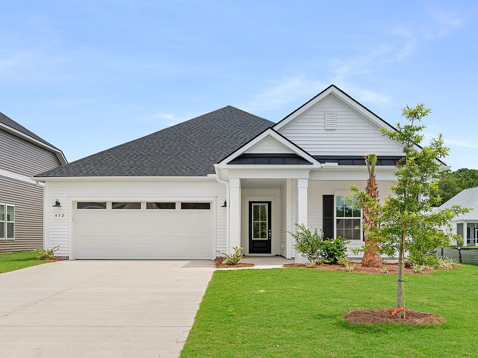 Charming front exterior with covered entry and two-car garage at 432 Summerwind Drive in Summerwind